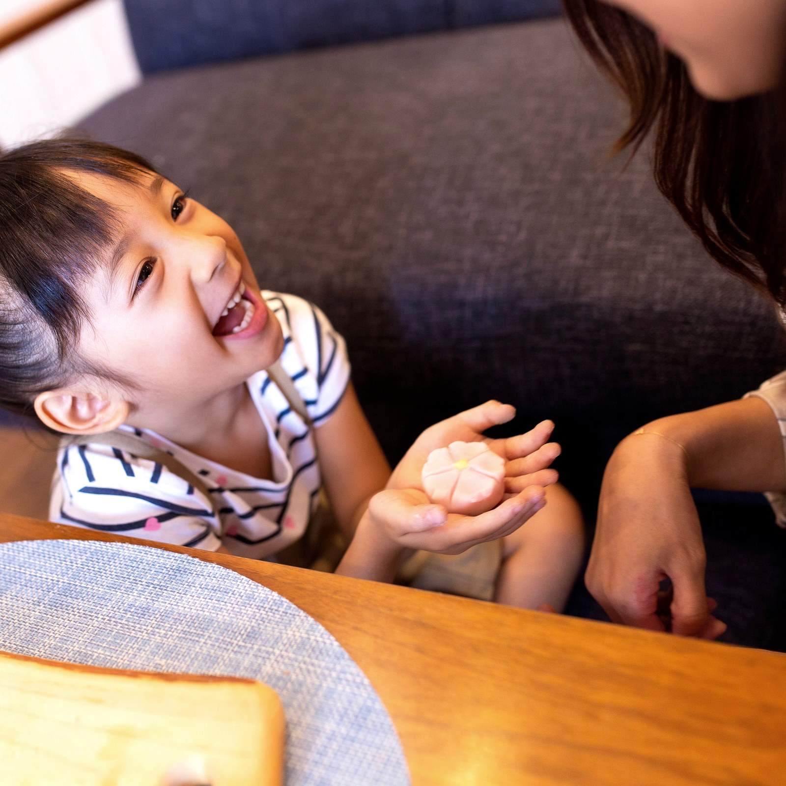 Child showing finished wagashi with a smile