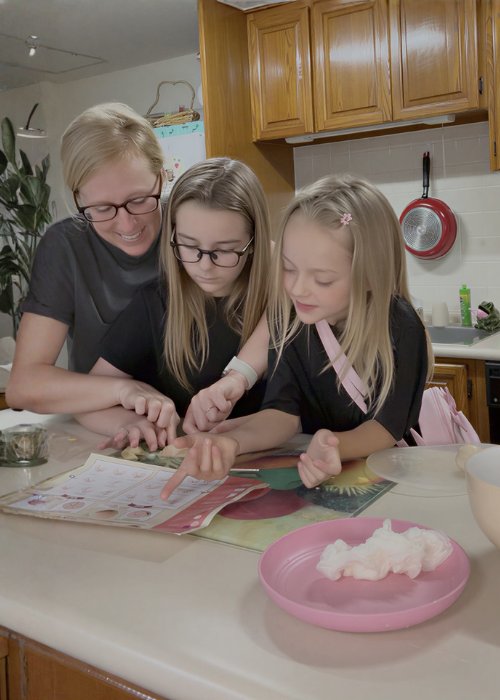 A mother and two daughters making wagashi together